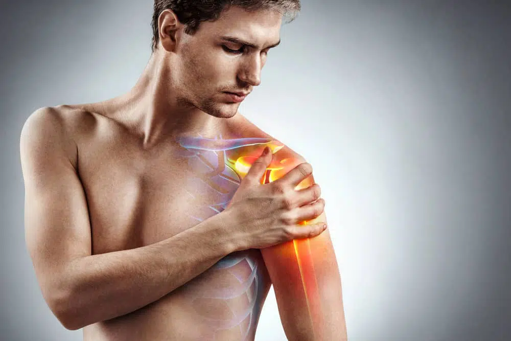 man with Shoulder Pain holds arm