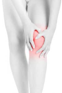 Woman holding knee with her hands that is inflamed 